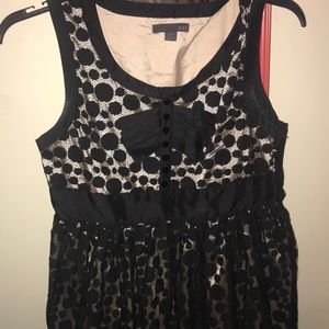 A tan and black bow dress